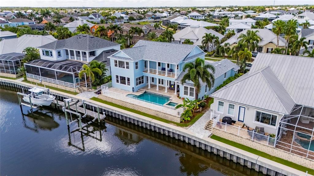 Aerial of 715 Islebay Drive showing the pool, dock and boat lift on the canal