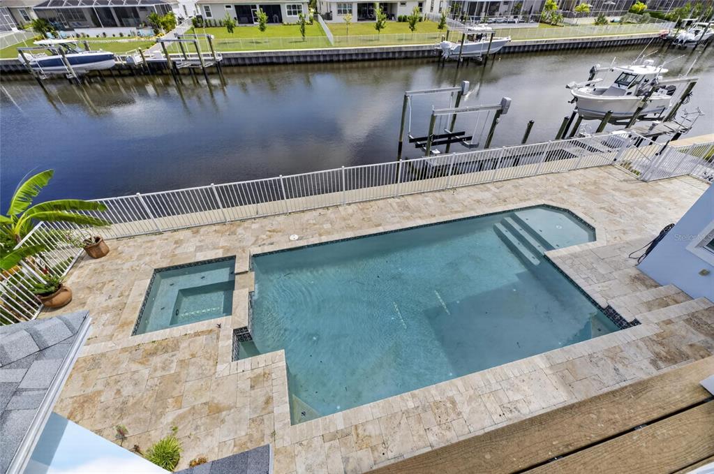 Heated pool and spa with travertine deck at 715 Islebay Drive Apollo Beach