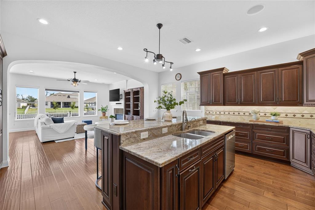Custom kitchen with granite counters and a large island at 715 Islebay Drive