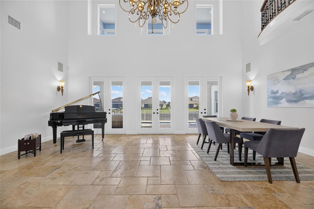Living room with tall windows overlooking the canal at 715 Islebay Drive
