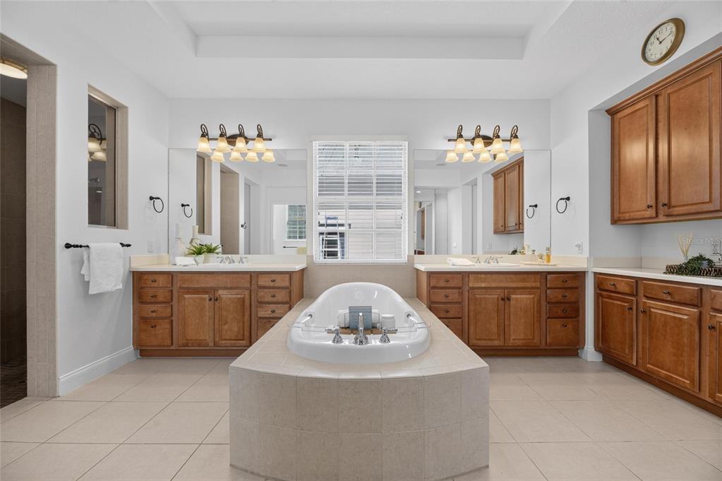 Primary bathroom with split vanities and soaking tub at 715 Islebay Drive