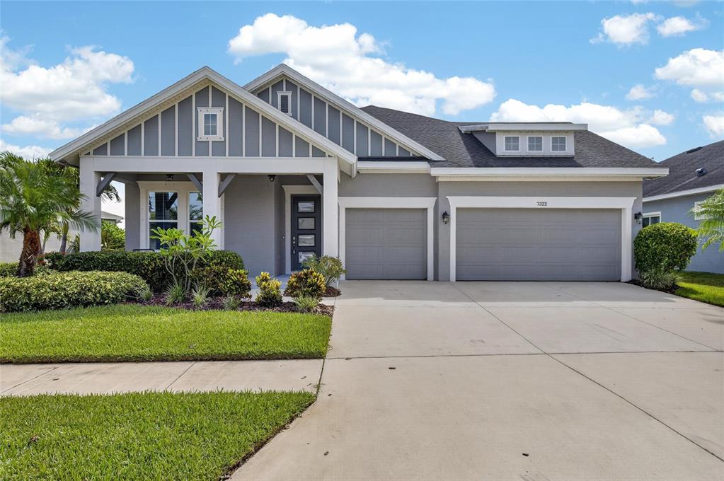 Craftsman-style front of 7322 Paradiso Drive with 3-car garage