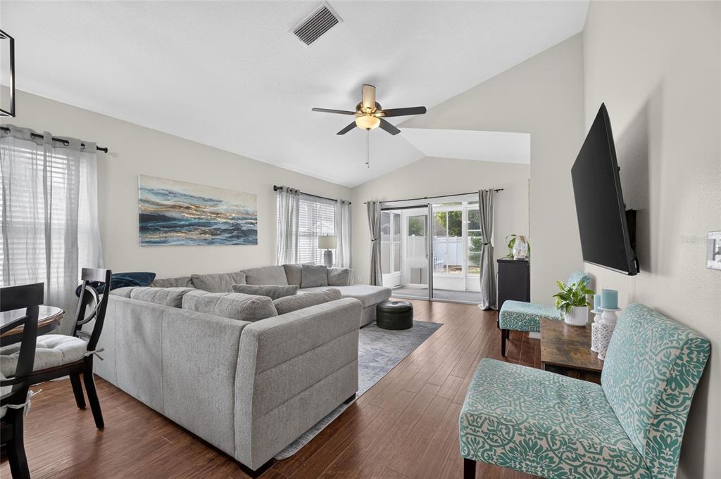 Vaulted living area with wood floors