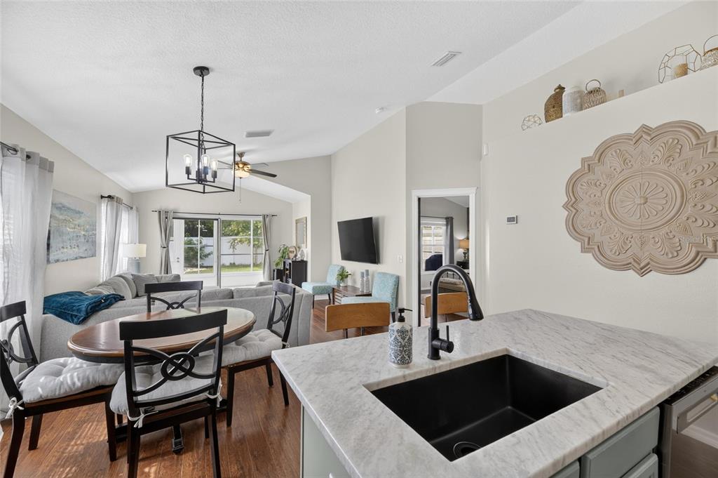 Kitchen with marble counters, island and gas range