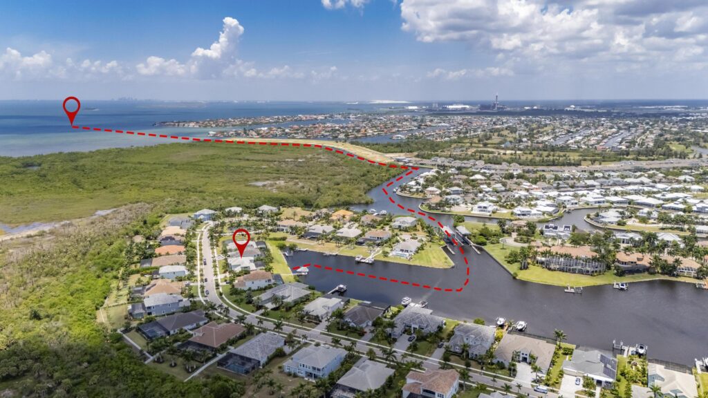 Aerial over the MiraBay lagoon toward Tampa Bay from 825 Manns Harbor Drive in Apollo Beach, Florida