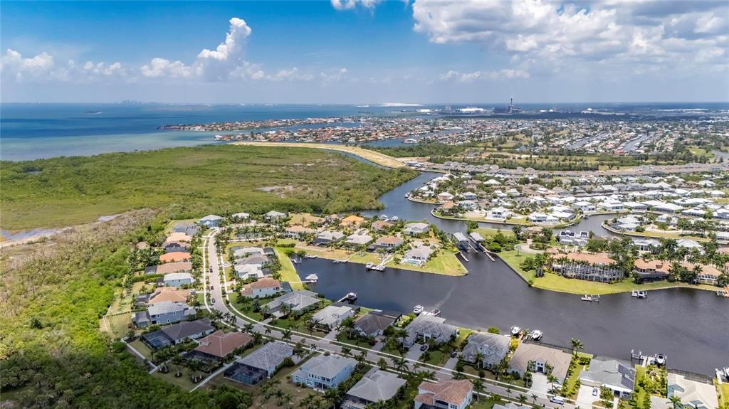 Aerial of 825 Manns Harbor Drive in MiraBay, Apollo Beach, with the lagoon, the Wolf Creek preserve and Tampa Bay beyond