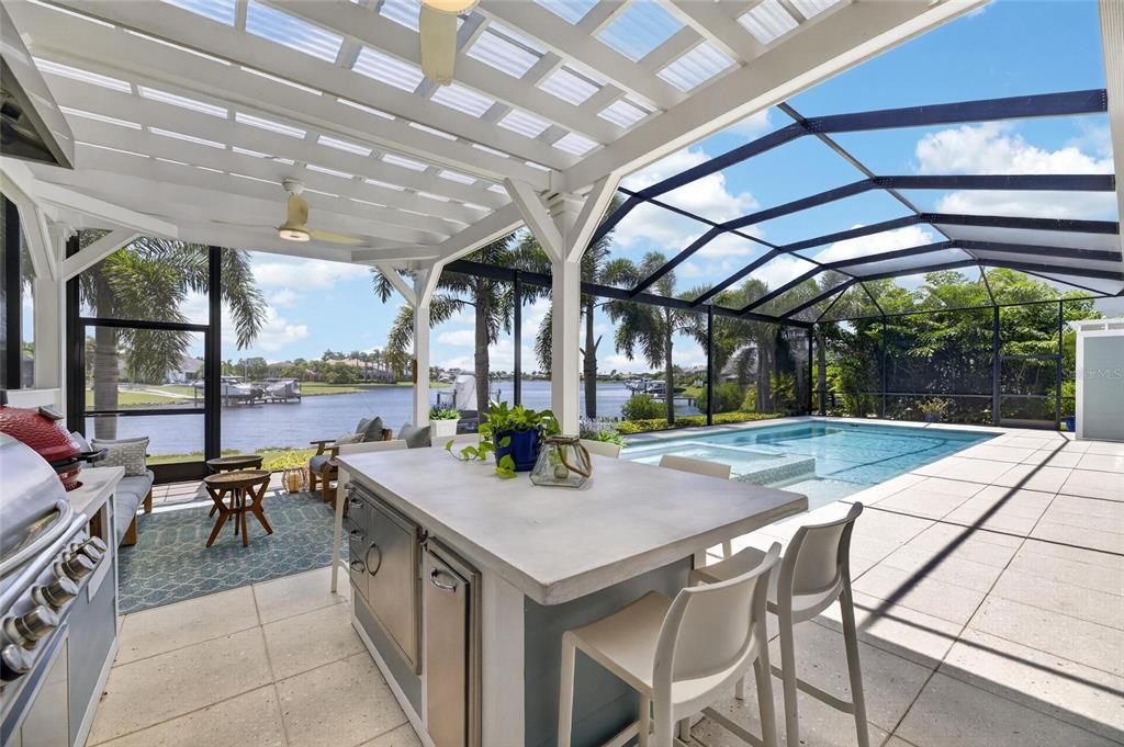 Covered lanai and pool with lagoon views at 825 Manns Harbor Drive