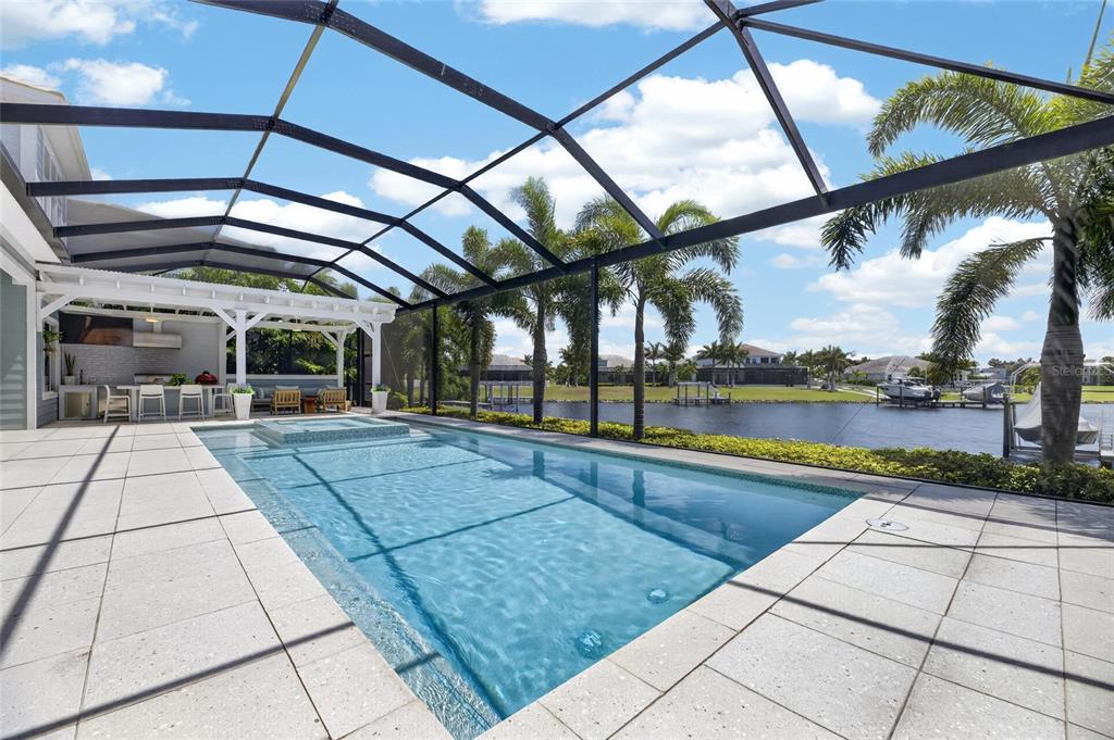 Screened heated pool overlooking the MiraBay lagoon at 825 Manns Harbor Drive