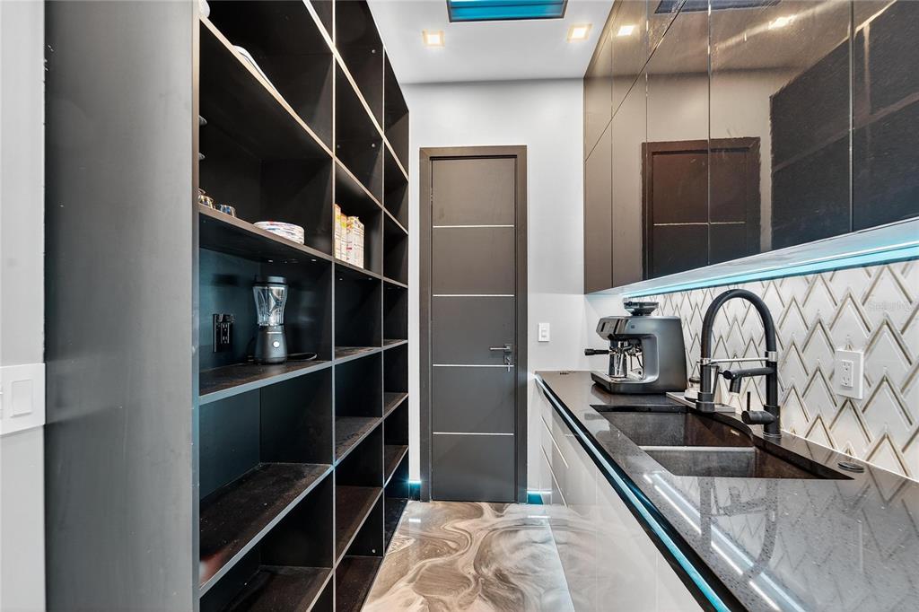 Chef’s kitchen with gas appliances and double ovens at 9600 Gulf Boulevard
