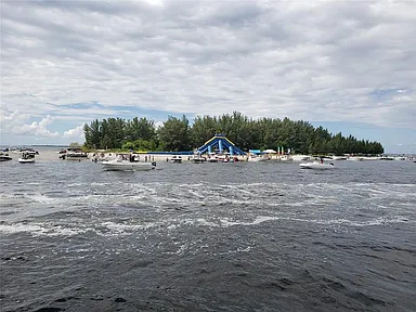 Boats rafted up along the shore of Beer Can Island off Apollo Beach, Florida in Tampa Bay