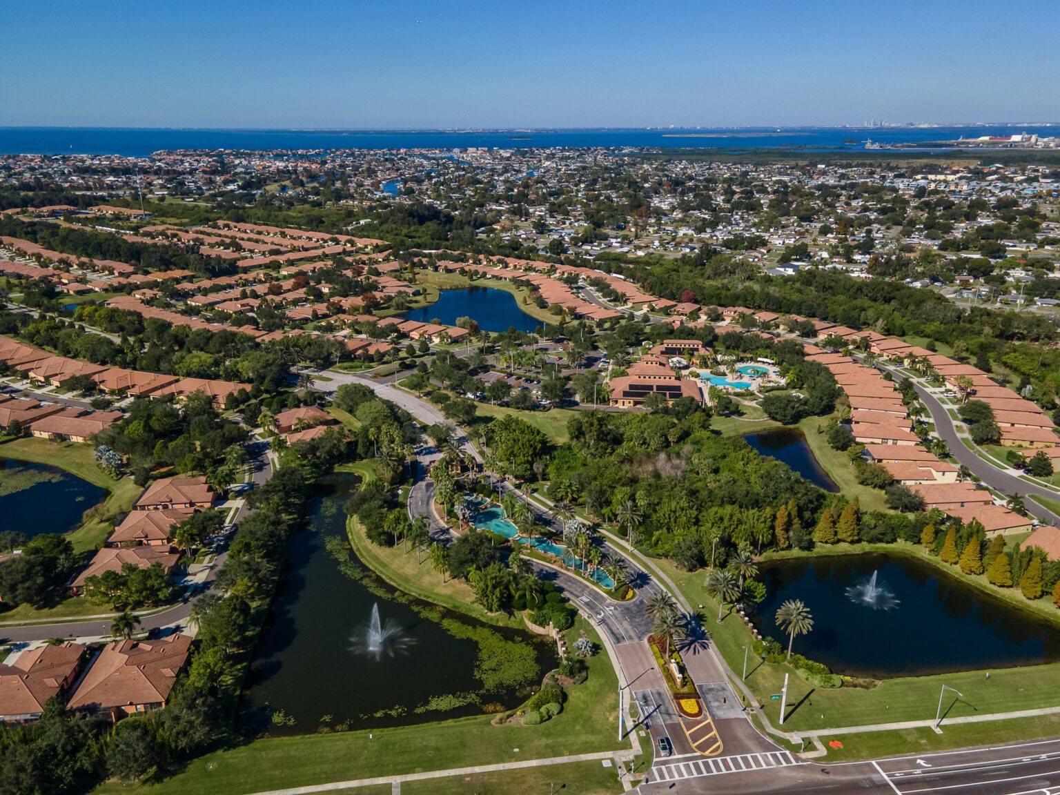 Aerial of Del Webb Southshore Falls, Apollo Beach, showing the ponds, rooftops and Tampa Bay beyond