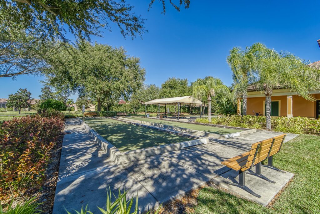 Shaded walking trail with benches at Del Webb Southshore Falls, Apollo Beach