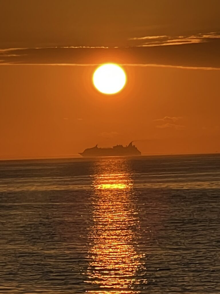 Cruise ship passing at sunset, seen from Apollo Beach, Florida