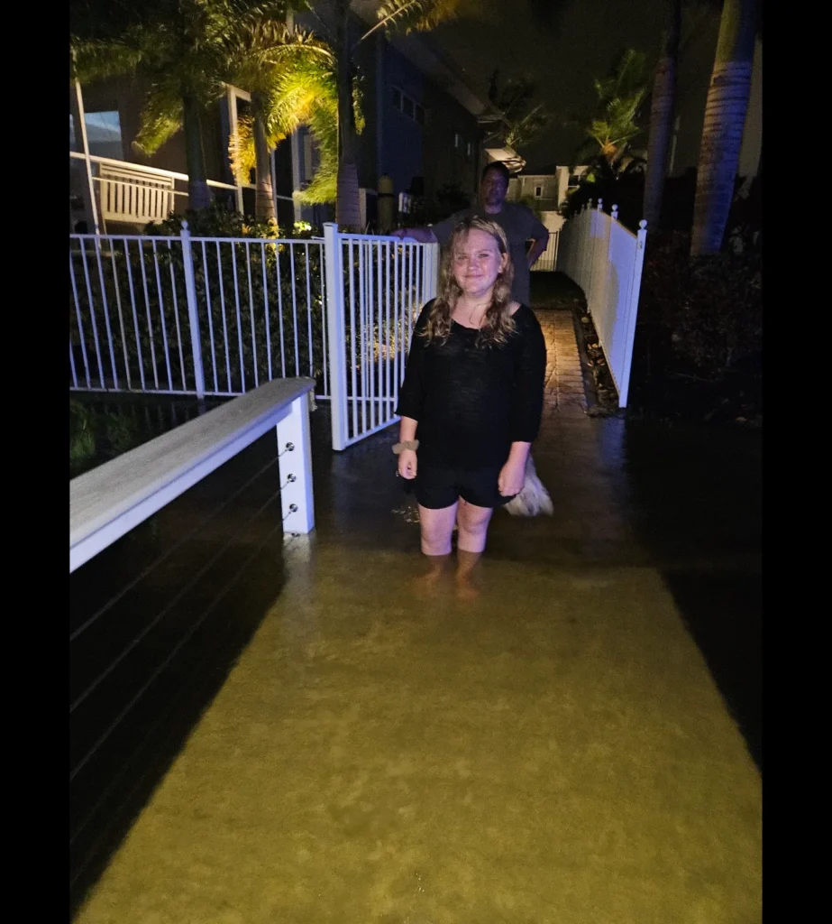 Storm surge water covering the Calvert family's dock at night during a hurricane in Apollo Beach, FL